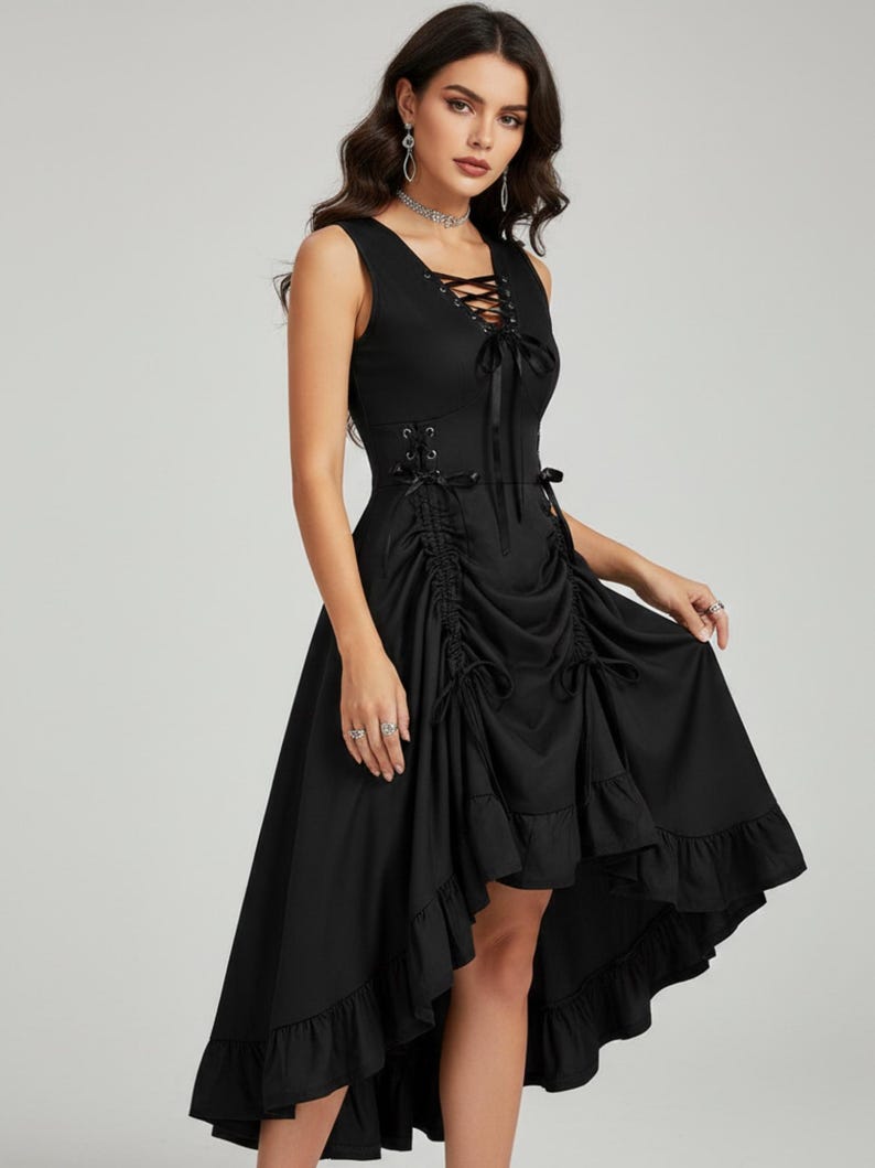 May include: A sleeveless black dress with a lace-up bodice and a high-low hemline. The dress features a ruched waist and ruffled trim. The model is wearing the dress. The dress is a gothic style.