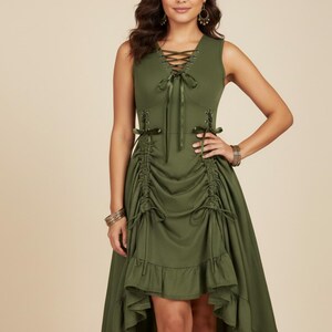 May include: Olive green sleeveless dress with a lace-up bodice and a high-low hemline. The dress features ruched detailing and ribbon ties. The model is wearing bracelets and earrings. The dress is a solid color and has a flowing skirt.