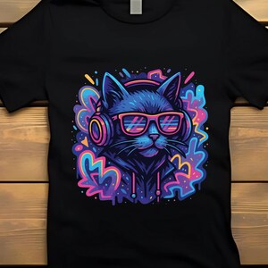 May include: Black t-shirt featuring a vibrant graphic of a cat wearing headphones and sunglasses. The cat is depicted in shades of blue and purple, with colorful accents. The design has a modern, digital art style.