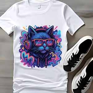 May include: White t-shirt featuring a vibrant graphic of a black cat wearing headphones and pink sunglasses. The cat is set against a colorful, abstract background. A pair of white sneakers with black accents are next to the shirt.