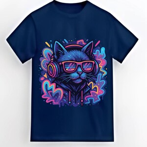 May include: Navy blue t-shirt featuring a cartoon cat wearing headphones and sunglasses. The cat is depicted in shades of blue, with pink and yellow accents. The graphic has a vibrant, colorful design, perfect for cat lovers.