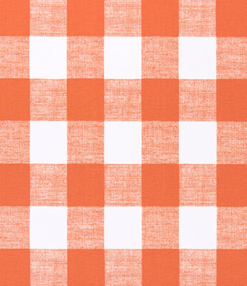 May include: A white and orange checkered fabric with a subtle texture.