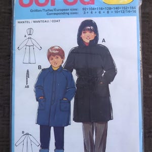 May include: A Burda 7187 sewing pattern envelope for a coat in European sizes 92 through 164. The cover features illustrations of two coats: a black hooded coat with a tie waist and a blue collared coat with buttons and pockets, both shown on figures.