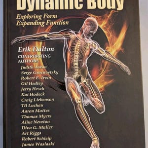 May include: A black hardcover book titled Dynamic Body: Exploring Form Expanding Function by Erik Dalton. The cover features a translucent anatomical illustration of a human figure in motion against a fiery orange and black circular background.