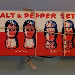 May include: A rectangular cardboard box labeled 4 PAIRS SALT & PEPPER SET HAND PAINTED, tied with string. The box features illustrations of four pairs of character-themed salt and pepper shakers labeled Papa, Mama, Brother, and Sister in red and white.