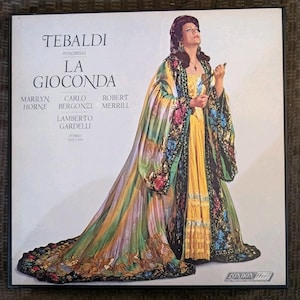 May include: A square vinyl record cover for Ponchielli's La Gioconda featuring Tebaldi. The cover art displays a person in a long, flowing yellow dress with a multi-colored, patterned cape and dark trim. Text includes names of performers and the London ffrr logo.