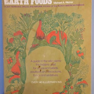 May include: A softcover book titled Earth Medicine-Earth Foods by Michael A. Weiner. The tan cover features green line illustrations of various plants, red berries, and orange pumpkins, along with descriptive text about wild plant remedies.
