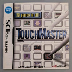 May include: A Nintendo DS TouchMaster instruction booklet featuring a white cover with a grid of small game screen icons, the title TouchMaster in blue text, the text 23 games in all!, and two white stylus pens angled across the front.