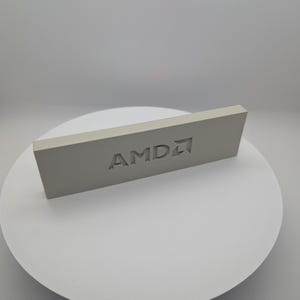 May include: A white rectangular block with the word "AMD" embossed on it.