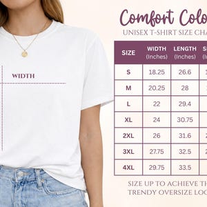 May include: A white t-shirt size chart for Comfort Colors featuring a table with width, length, and sleeve measurements in inches for sizes S through 4XL. The chart includes a visual guide on a white t-shirt showing where width and length are measured.
