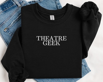 May include: Black sweatshirt with the text "THEATRE GEEK" printed in white on the front.