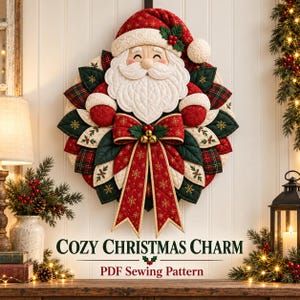 May include: A quilted fabric Santa Claus wall hanging featuring a red hat, white beard, and a large red bow with gold snowflake patterns. The design includes green and red fabric leaves arranged in a circular wreath shape. Text reads: COZY CHRISTMAS CHARM PDF Sewing Pattern.