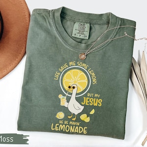 Comfort Colors® Life Gave Me Some Lemons But My Jesus He Be Makin' Lemonade Silly Goose Shirt, Christian Gift For Women, Faith Apparel Unisex Moss