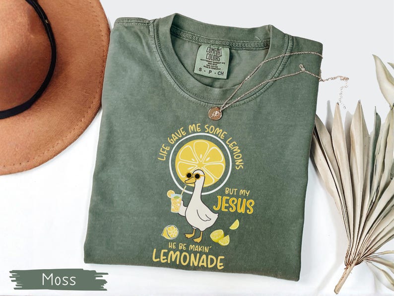 Comfort Colors® Life Gave Me Some Lemons But My Jesus He Be Makin' Lemonade Silly Goose Shirt, Christian Gift For Women, Faith Apparel Unisex Moss