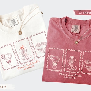 Custom bachelorette beach matching shirts with coastal doodle illustrations, including cocktails, shells, oysters, and bikinis. Personalized bride squad tees for beach trips, bridesmaids, and bach party vacations.