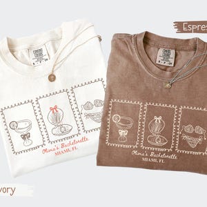 Custom bachelorette beach matching shirts with coastal doodle illustrations, including cocktails, shells, oysters, and bikinis. Personalized bride squad tees for beach trips, bridesmaids, and bach party vacations.