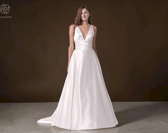 Minimalist Satin A-Line Wedding Dress: Halter Neck, Low Back, Pockets