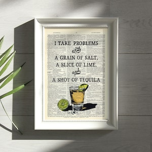 May include: A white framed print with a vintage dictionary page background. The text reads "I take problems with a grain of salt, a slice of lime, and a shot of tequila". A glass of tequila with a lime wedge and salt is illustrated.