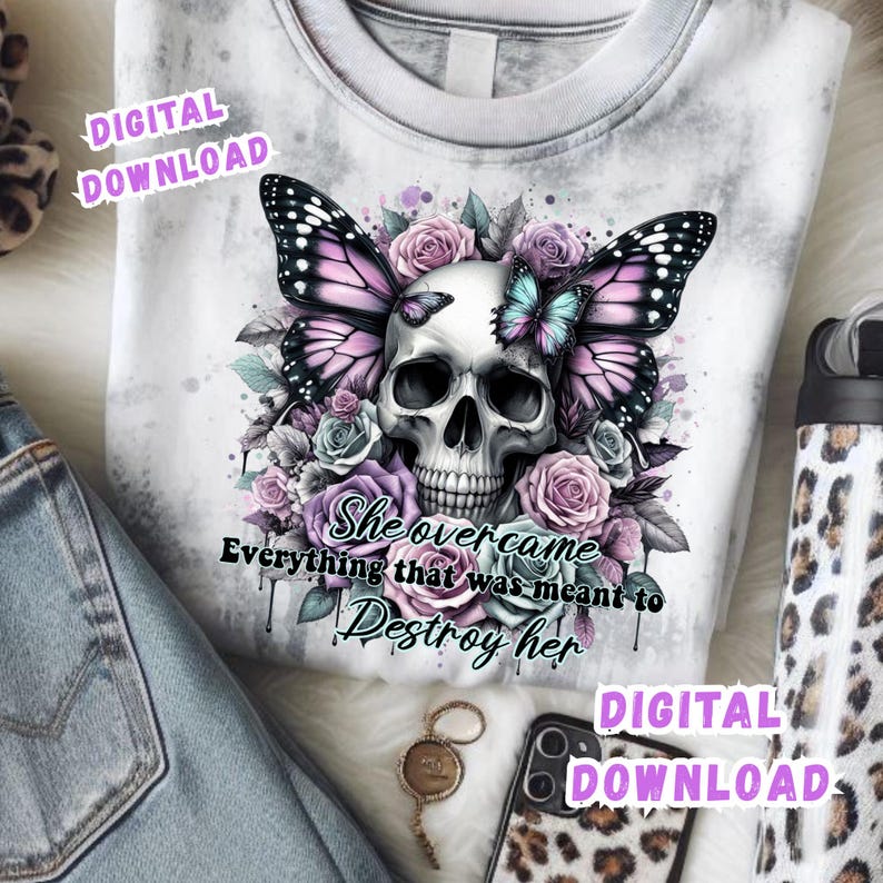 May include: White tie-dye sweatshirt featuring a skull with butterfly wings and floral accents in shades of purple, pink, and blue. The text "She overcame everything that was meant to destroy her" is below the skull. Digital download.