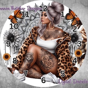 May include: A round clock face featuring a woman with tattoos, wearing a leopard print coat, and white sneakers. The clock face includes butterflies, sunflowers, and the text "Rhiannon Thatcher Designs" and "Digital Download".
