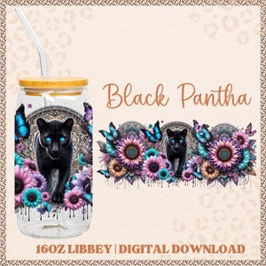 May include: A clear glass Libbey can with a bamboo lid and straw, featuring a black panther design with blue eyes, surrounded by flowers and butterflies. The text "Black Pantha" is displayed above the design.