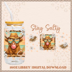 May include: A clear glass Libbey can with a bamboo lid and straw. The design features a brown Highland cow wearing heart-shaped sunglasses and a hat, blowing a bubblegum bubble. The words "Stay Salty" are written in a script font.