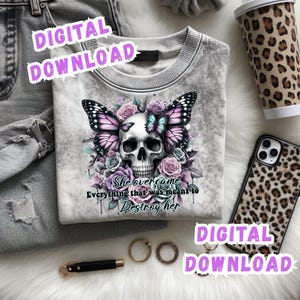 May include: A gray sweatshirt featuring a skull design with butterfly wings, surrounded by roses. The text "She overcame everything that was meant to destroy her" is below the skull. Accessories include a leopard print phone case and coffee cup.