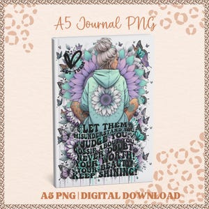 May include: A5 journal featuring a digital illustration of a woman in a hoodie, surrounded by butterflies and flowers. The cover displays the text "LET THEM MISUNDERSTAND YOU...KEEP SHINING!" in a stylish font. Digital download.