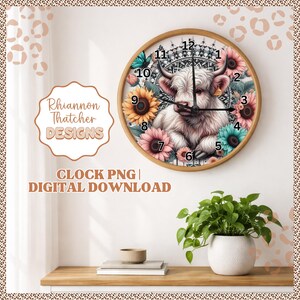 May include: A circular wall clock with a wooden surround. The clock face depicts a white Highland cow surrounded by sunflowers and other colourful flowers. The clock hands are black. The text "Rhiannon Thatcher DESIGNS" and "CLOCK PNG | DIGITAL DOWNLOAD" are also visible.