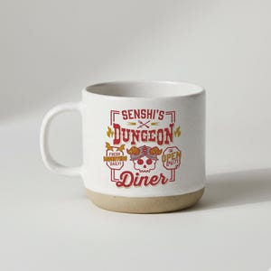 May include: White ceramic mug with a speckled finish and a tan base. The mug features the text "Senshi's Dungeon Diner" in a red and yellow design, with a skull graphic and the words "Fresh Monsters Daily!" and "Open 24/7!"