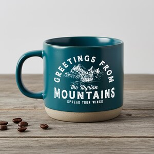 May include: A white ceramic mug with a black handle and the text "But First, Coffee" in a black, handwritten-style font. The mug is on a white surface.