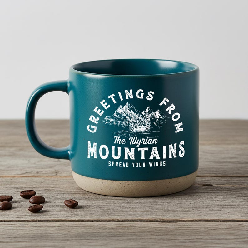 May include: A white ceramic mug with a black handle and the text "But First, Coffee" in a black, handwritten-style font. The mug is on a white surface.