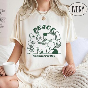 Peace and Love Pet Day T-Shirt - Cute Cat and Dog Cartoon - Animal Lover Gift - Unisex Casual Tee
