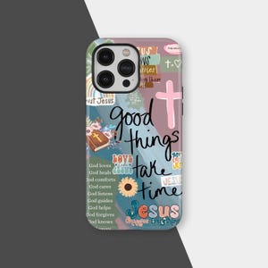 May include: A phone case with a colourful design featuring the words "good things take time" and "Jesus." The case has a pink cross, a sunflower, and other religious-themed graphics. The case also has the words "God loves" and other related phrases.