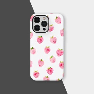 May include: White phone case featuring a pattern of pink watercolor strawberries with green leaves. The case has a black camera module and a glossy finish. The design is a repeating pattern of the fruit.