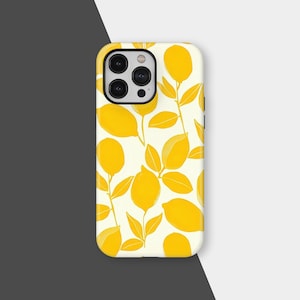 May include: A white phone case with a repeating pattern of yellow lemons and green leaves. The case has a glossy finish and a camera cutout on the upper left. The design is a bright and cheerful illustration.