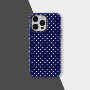 May include: A navy blue phone case with a white polka dot pattern. The case has a glossy finish and a camera cutout. The design features evenly spaced white dots against a dark blue background, creating a classic and stylish look.