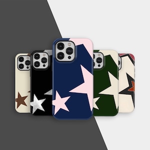 May include: A selection of phone cases with star designs. The cases display a range of colours, such as cream, black, navy, and green, with star patterns in contrasting colours like silver, pink, and brown. The cases are arranged in a line.