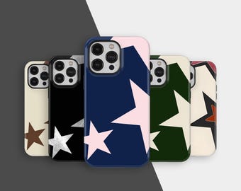 May include: A collection of phone cases with star patterns. The cases feature various colors, including cream, black, navy, and green, with star designs in contrasting colors like silver, pink, and brown. The cases are arranged in a row.