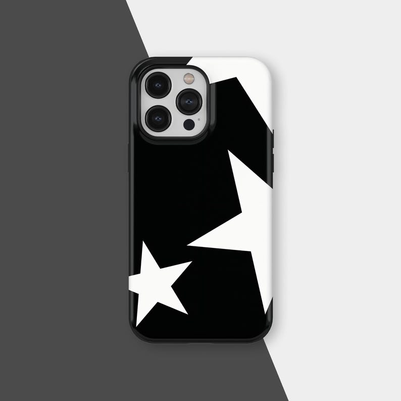 May include: Black and white phone case featuring a bold star pattern. The case has a black border and a glossy finish. The design includes multiple white stars of varying sizes against a black background.