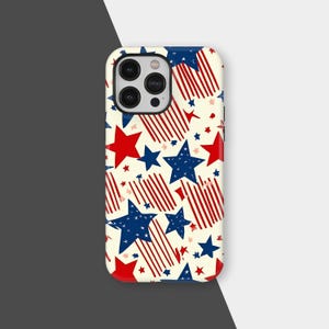 May include: A phone case with a cream background featuring a pattern of red and blue stars and red and white stripes. The case has a glossy finish and a camera cutout.