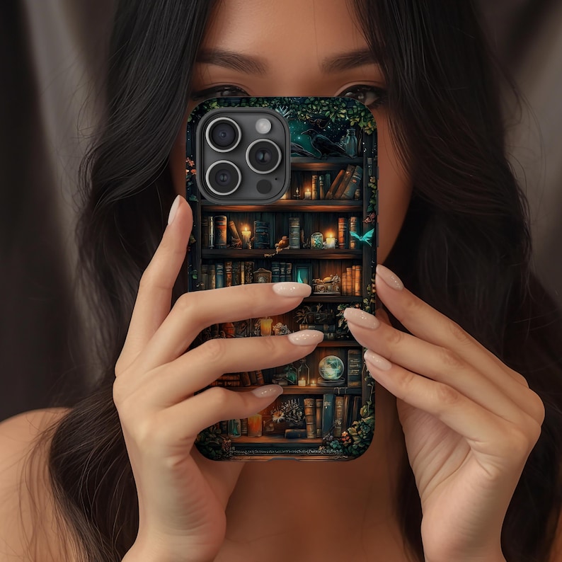 May include: A phone case featuring a detailed illustration of a bookshelf filled with books, candles, and decorative items. The design incorporates a dark color palette with hints of green and gold, creating a fantasy theme. The case has a glossy finish.