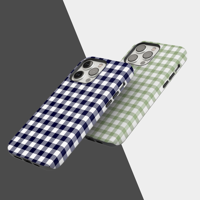 May include: Two phone cases with a gingham pattern. One case is navy blue and white, and the other is light green and white. The cases are angled, showcasing the design and the camera cutouts.