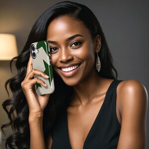 May include: A smartphone case with a beige background and a green star pattern. The case is held by a person with long, dark hair and a black dress. The person is smiling.