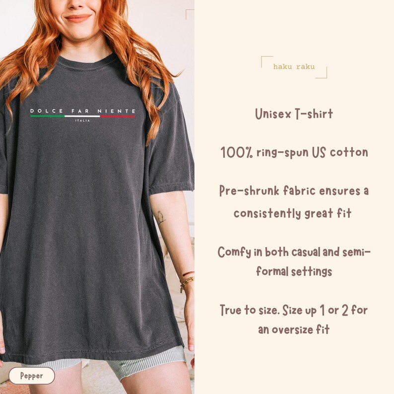 May include: A dark gray unisex t-shirt with the text "DOLCE FAR NIENTE" in white, green, and red, with "ITALIA" below. The shirt is made of 100% ring-spun US cotton and is pre-shrunk. The brand name "haku raku" is also visible.