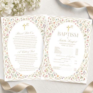 May include: Two rectangular baptism program cards featuring a delicate floral pattern with small pink, blue, and yellow flowers. Each card has a central oval frame containing gold text, a gold cross, and a dove icon. The text includes "Blessed Little One" and "BAPTISM of Isabella Langford" with lines for event details.