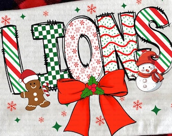 May include: A white t-shirt with the word "LIONS" in a festive design. The letters feature patterns like candy cane stripes, snowflakes, and a green checkerboard. Includes a gingerbread man, snowman, and a red bow. The text "digital download" is also present.
