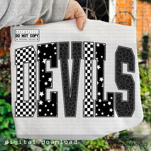 May include: A white fabric with the word "DEVILS" in a bold, block letter design. The letters feature various patterns, including black and white checkered, star-filled, and leopard print. The design includes the text "DO NOT COPY" and "ORIGINAL DESIGN".