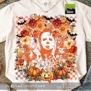 May include: White t-shirt featuring a Halloween-themed design. The graphic includes a portrait of a character, pumpkins, flowers, and bats. The text "I CAME BACK" is also visible. The shirt is a Comfort Colors brand.