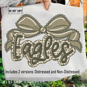 May include: A digital download design featuring the word "Eagles" in a camouflage pattern with a decorative bow. The design includes two versions: distressed and non-distressed. The text "designwinco DO NOT COPY ORIGINAL DESIGN" is also visible.